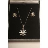 A DIAMOND PENDANT AND MATCHING EAR STUDS, the open flower pendant set with small round brilliant and