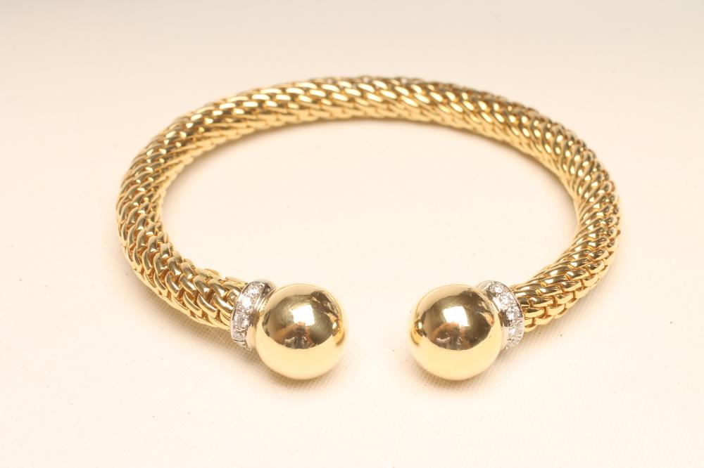A "FOPE" 18CT GOLD TORQUE BANGLE, the cylindrical "fixed" chain with ball finials each with a collar