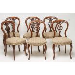A SET OF SIX VICTORIAN WALNUT DINING CHAIRS of open spoonback form upholstered in ivory ground