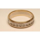 A DIAMOND HALF HOOP ETERNITY RING, the 18ct white gold band channel set with nine round brilliants