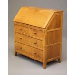 AN ADZED OAK BUREAU by R.G. Heap of Driffield, the fall front enclosing interior fitted with