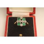 AN ART DECO EMERALD AND DIAMOND DRESS RING, the square panel open back collet set with four