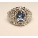 A SAPPHIRE AND DIAMOND COCKTAIL RING, the oval cut sapphire of approximately 2.60cts claw set to a