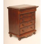 A VICTORIAN MAHOGANY MINIATURE CHEST, the stepped and moulded cornice over secret cushion frieze