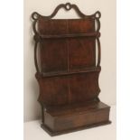 A GEORGIAN OAK SPOON RACK, 18th century, the boarded back fitted with a pair of notched rails within