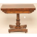 A REGENCY ROSEWOOD FOLDING CARD TABLE of rounded oblong form lined with red baize, tablet frieze