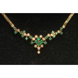 AN EMERALD AND DIAMOND NECKLACE, the central cluster with fixed drop on an asymetrically set emerald