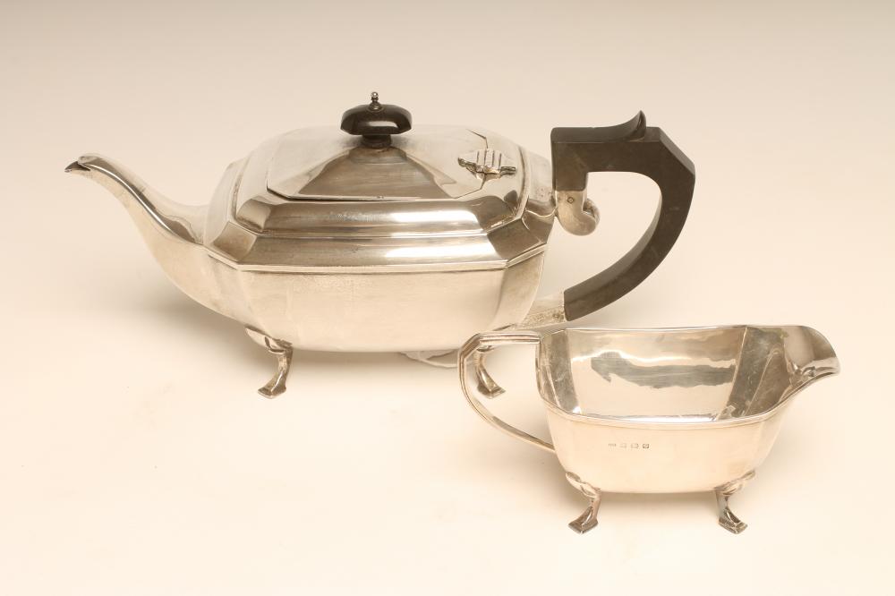 AN ART DECO SILVER TEAPOT AND MILK JUG, maker's mark JR, Birmingham 1931, of canted oblong form, the