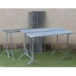 A PAIR OF GALVANISED IRON GREENHOUSE STANDS, each comprising two oblong pierced honeycomb panels, on