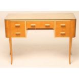 AN ART DECO SATIN BIRCH AND PAINTED SIDE TABLE of rounded oblong kneehole form, arched frieze drawer