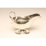 A SILVER SAUCEBOAT, makers Deakin & Francis, Birmingham 1929, the plain oval band with double "C"