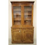 A VICTORIAN BURR WALNUT BOOKCASE of two stage shallow rounded oblong form, the ogee moulded