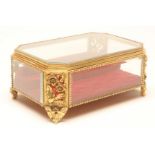 A GLASS AND GILT METAL JEWELLERY CASKET, late 19th century, of canted oblong form, the bevelled