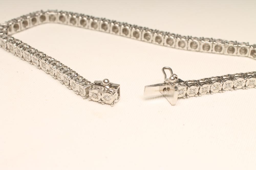 A DIAMOND TENNIS BRACELET, the fifty illusion set stones each of approximately 0.032cts on an 18ct - Bild 2 aus 2