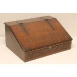 A GEORGIAN OAK BOARDED DESK BOX, 18th century, the moulded edged sloping lid with wrought iron strap