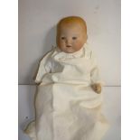 An Armand Marseille Chinese bisque head baby doll with blue glass sleeping eyes, open mouth and