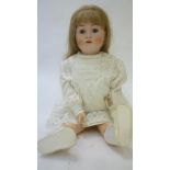 A Kestner bisque head doll with blue glass sleeping eyes, open mouth and teeth, brown mohair wig,