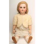 A Jumeau S.F.B.J. bisque head doll with brown glass sleeping eyes, open mouth and teeth, pierced