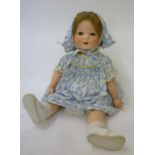 An Armand Marseille bisque head character doll with brown glass sleeping eyes, open mouth and teeth,