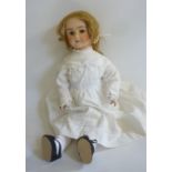 An A. Lanternier & Cie bisque head doll with fixed brown glass eyes, open mouth and teeth, pierced