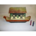 A mid 20th century German Noah's Ark in painted wood, with hinged roof, 18" long, two figures, eight