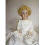 A Kammer & Reinhardt bisque head character doll with blue glass sleeping eyes, open mouth and teeth,