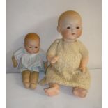 An Armand Marseille bisque head baby doll with blue glass sleeping eyes, closed mouth, moulded hair,