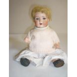 An Armand Marseille bisque head doll with blue glass sleeping eyes, open mouth and teeth, blonde