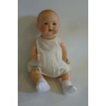 An Armand Marseille bisque head "Dream Baby" doll with blue glass sleeping eyes, open mouth and