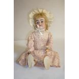 A Kestner bisque head doll with blue glass sleeping eyes, open mouth and teeth, blonde mohair wig,