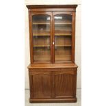 A VICTORIAN MAHOGANY TWO STAGE BOOKCASE of rounded oblong form, the moulded cornice and plain frieze