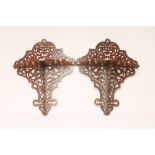 A PAIR OF VICTORIAN WALNUT WALL BRACKETS, the wave edged shelf with scroll pierced fret support