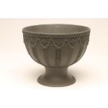 A VICTORIAN WEDGWOOD BLACK JASPERWARE PEDESTAL BOWL, the deep circular bowl with a sprigged rope