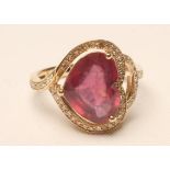 A RED SPINEL AND DIAMOND DRESS RING, the heart cut spinel of approximately 4.25cts claw set to a