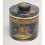 "THE HUMIDOR "TOBACCO JAR"", an Art Deco Carlton ware pottery cylindrical jar and lift off cover,