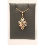 AN OPAL PENDANT, the open leaf shaped 9ct gold panel inset with six claw set opals on a plain bale