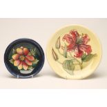 TWO MOORCROFT POTTERY PLATES, 1950's, comprising a yellow ground Tiger Lily pattern plate, 10 1/4"