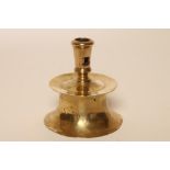 A BRASS HEEMSKIRK CANDLESTICK, 17th century, the turned socket raised on a capstan base, 4 1/2" high