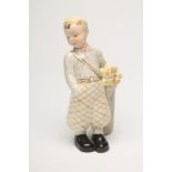 A GOLDSCHEIDER EARTHENWARE FIGURE, 1930's, of a young boy golfer, wearing a yellow beret, grey