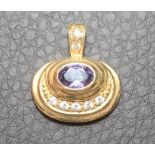 A PENDANT to match the previous lot, set with a purple sapphire, the reeded bale set with two