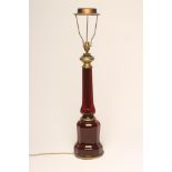 A RUBY GLASS ELECTRIC TABLE LAMP BASE, c.1930's, the swept octagonal stem issuing from a multi