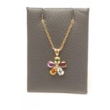 A MULTI-GEM PENDANT, the five mix cut stones including peridot, garnet and amethyst centred by a