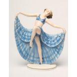 AN ART DECO KATZHUTTE EARTHENWARE OF A YOUNG DANCER wearing a blue spotted bikini top, her arms