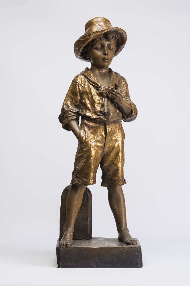 A LARGE GOLDSCHEIDER EARTHENWARE FIGURE, late 19th century, modelled as a young boy wearing a hat,