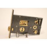 AN ELGOOD BROS. BRASS AND CAST IRON ASYLUM LOCK with treble throw horizontal mechanism, with key,