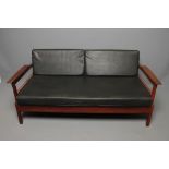 AN ENGLISH TEAK FRAMED SOFA BED, 1960's, with loose cushions in black leatherette, angled single