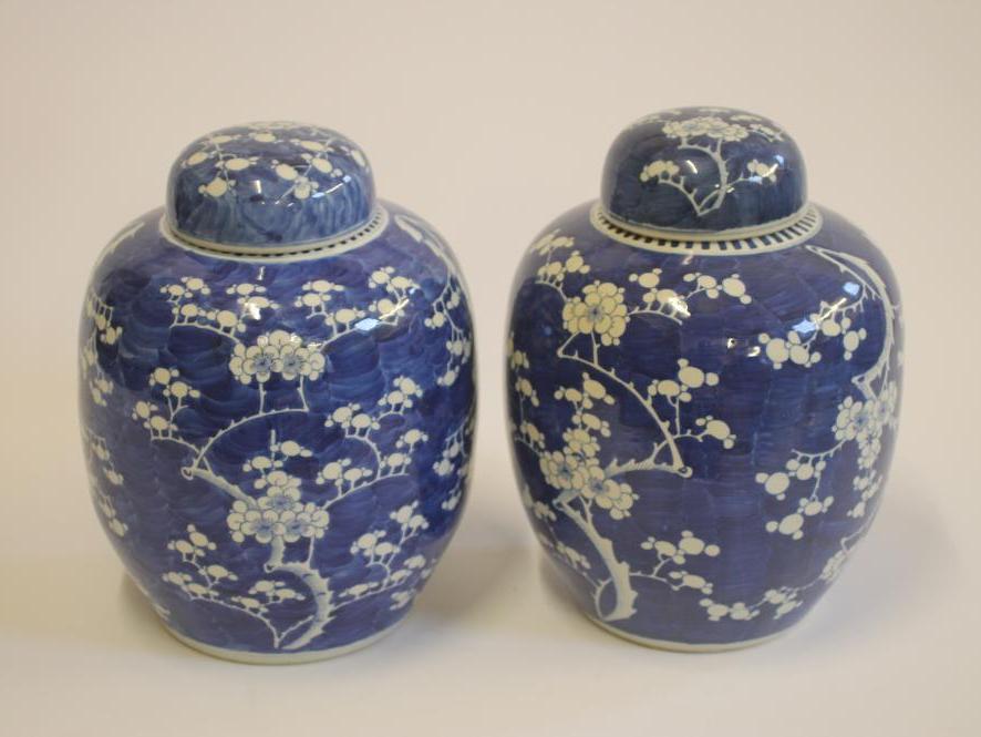 A PAIR OF CHINESE PORCELAIN LARGE JARS AND COVERS of ovoid form, painted in underglaze blue with the