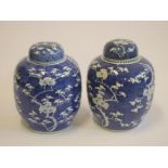 A PAIR OF CHINESE PORCELAIN LARGE JARS AND COVERS of ovoid form, painted in underglaze blue with the