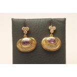 A PAIR OF PINK SAPPHIRE AND DIAMOND PENDANT EAR STUDS, the oval facet cut sapphires collet set to