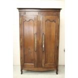 A FRENCH CHESTNUT ARMOIRE, early/mid 19th century, the moulded cornice over two arched panelled
